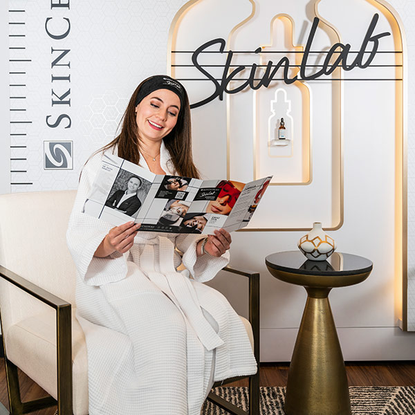 women reading magazine and smiling